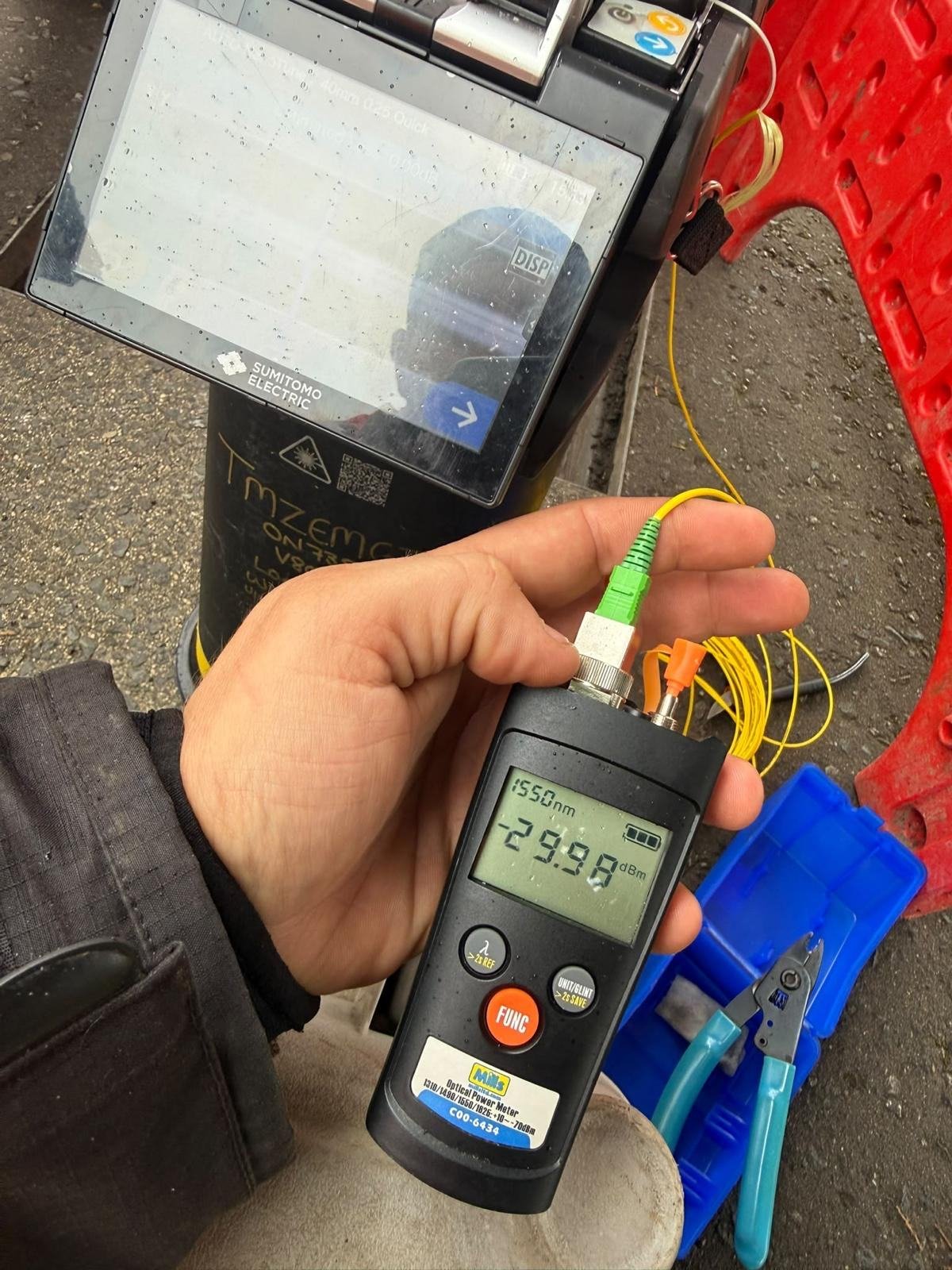Optical power meter reading taken beside a fusion splicer